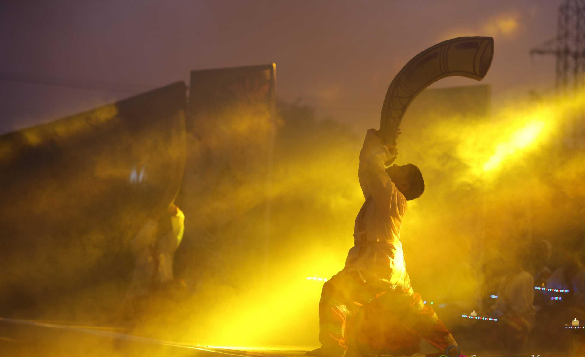 Outdoor Founder's Day performance with golden lighting and haze