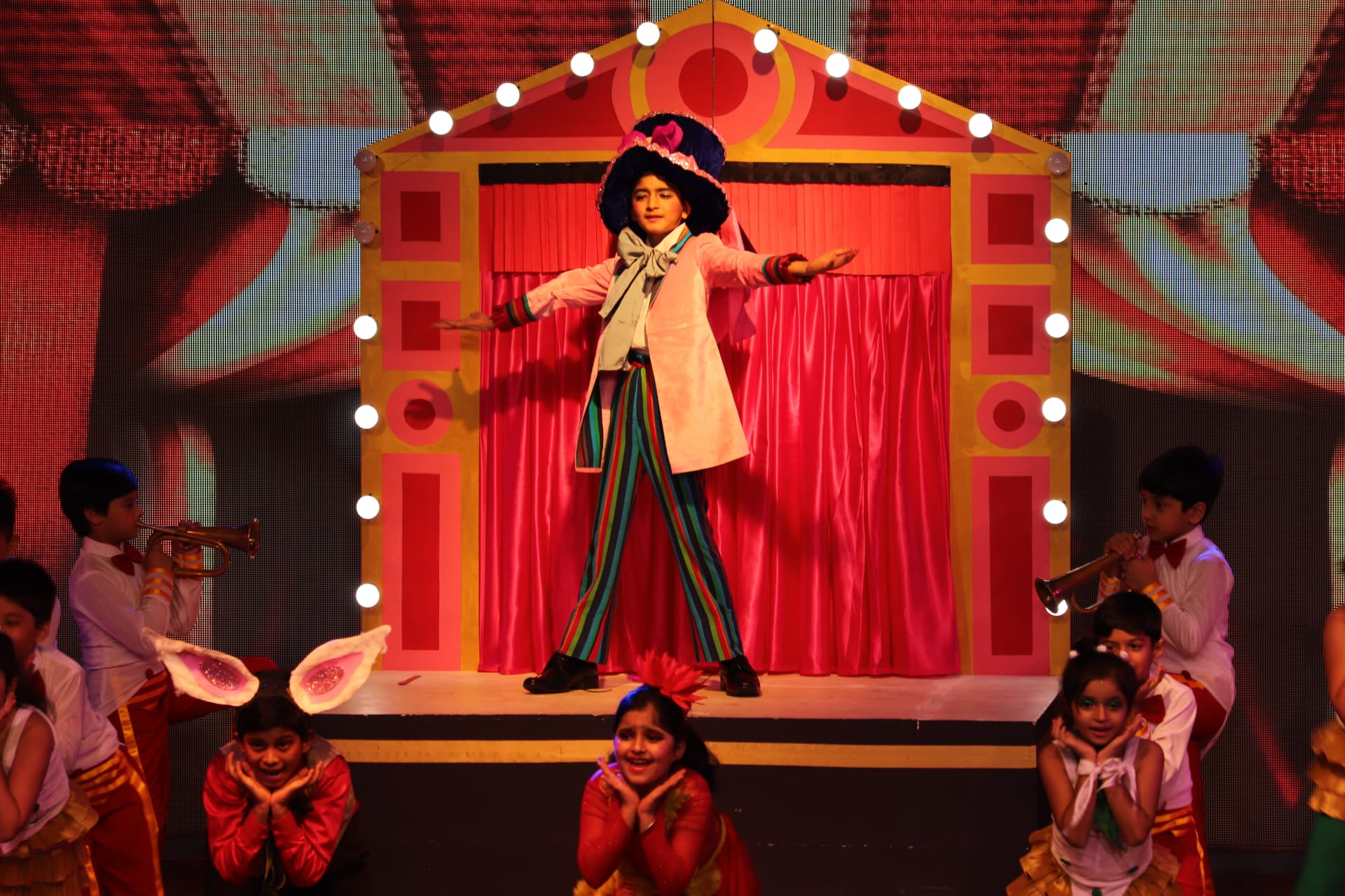 Children performing a circus themed annual day musical with a painted set
