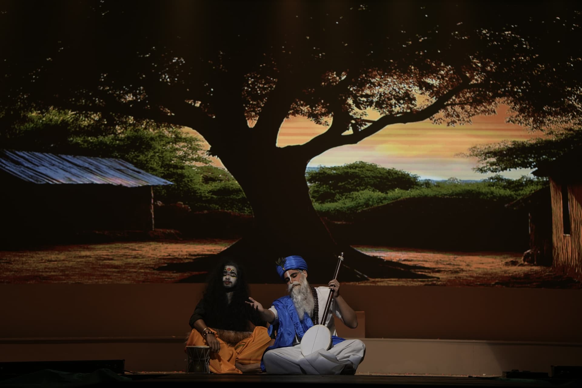 Students in character playing live instruments during a school theatre production