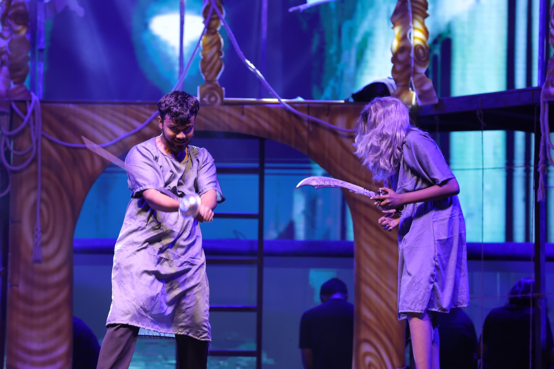 Dramatic sword fight scene staged by students in a school theatre production